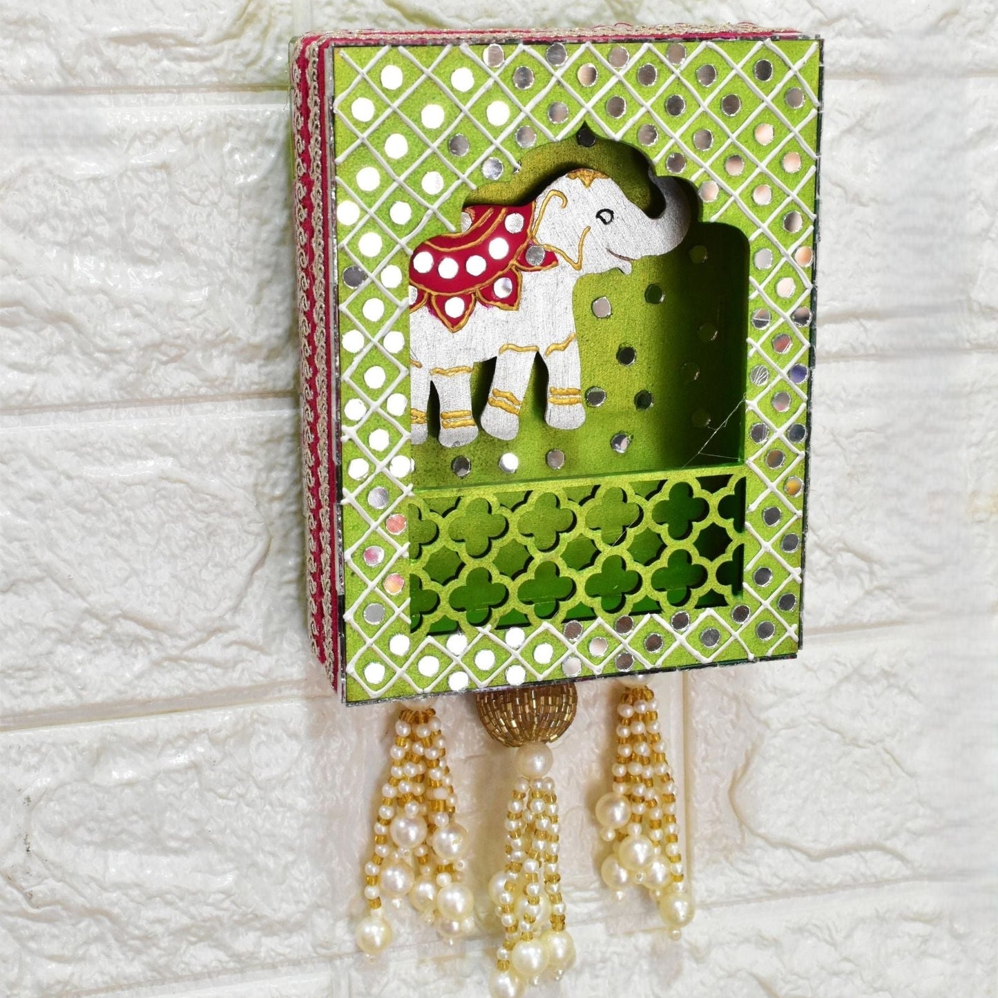 Decorative jharokha wall art with an elephant design on a textured white background