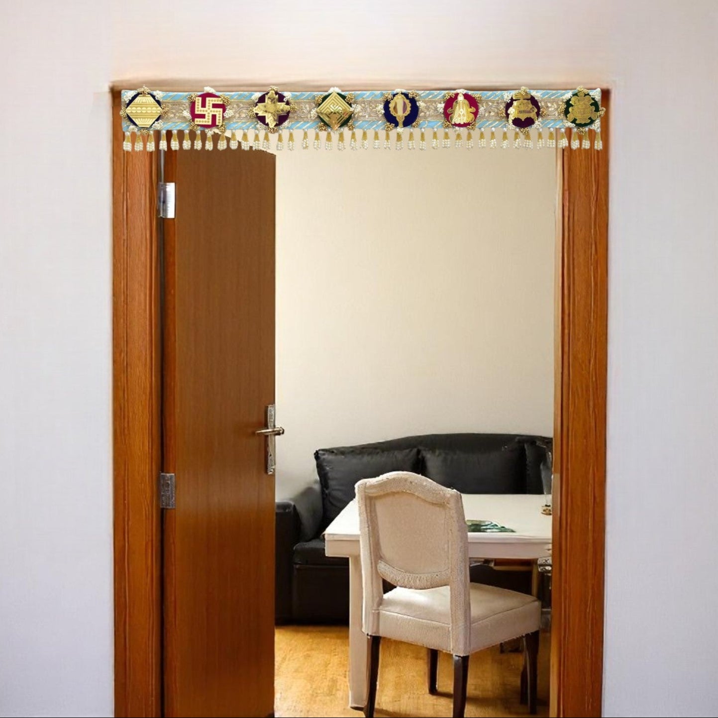 Decorative Toran door hanging above a doorway made with a theme of ashtamangal jain symbols