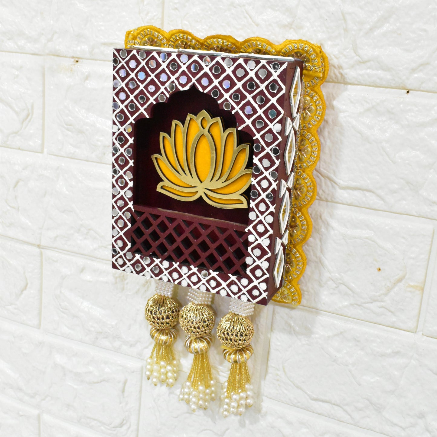 Brown rectangular Indian jharokha wall hangings with lotus motifs, decorative patterns, and tassels, displayed against a light background.