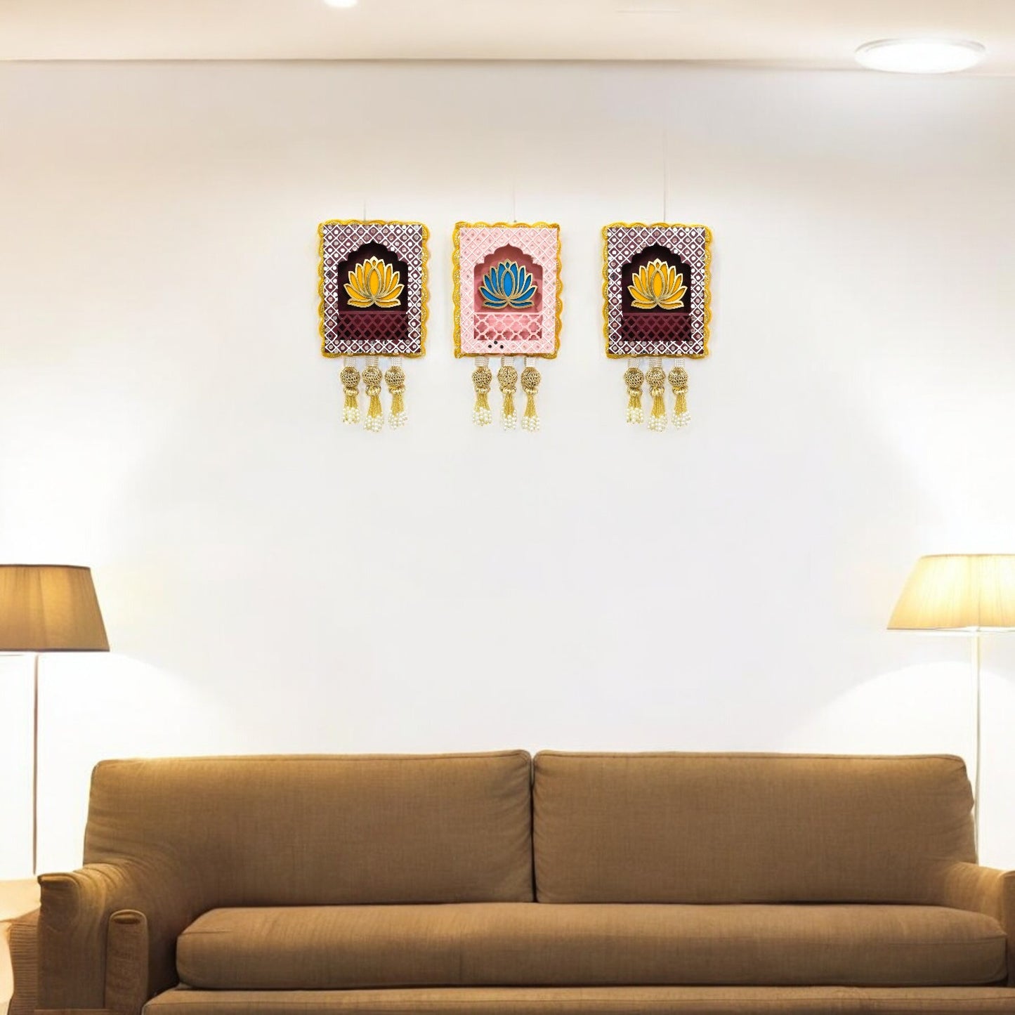 Three rectangular Indian jharokha wall hangings with lotus motifs, decorative patterns, and tassels, displayed against a light background in the living room.