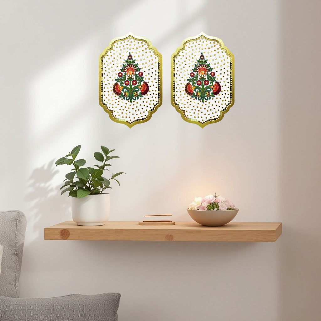 Two decorative wall hangings with floral patterns on a white wall above a wooden shelf.