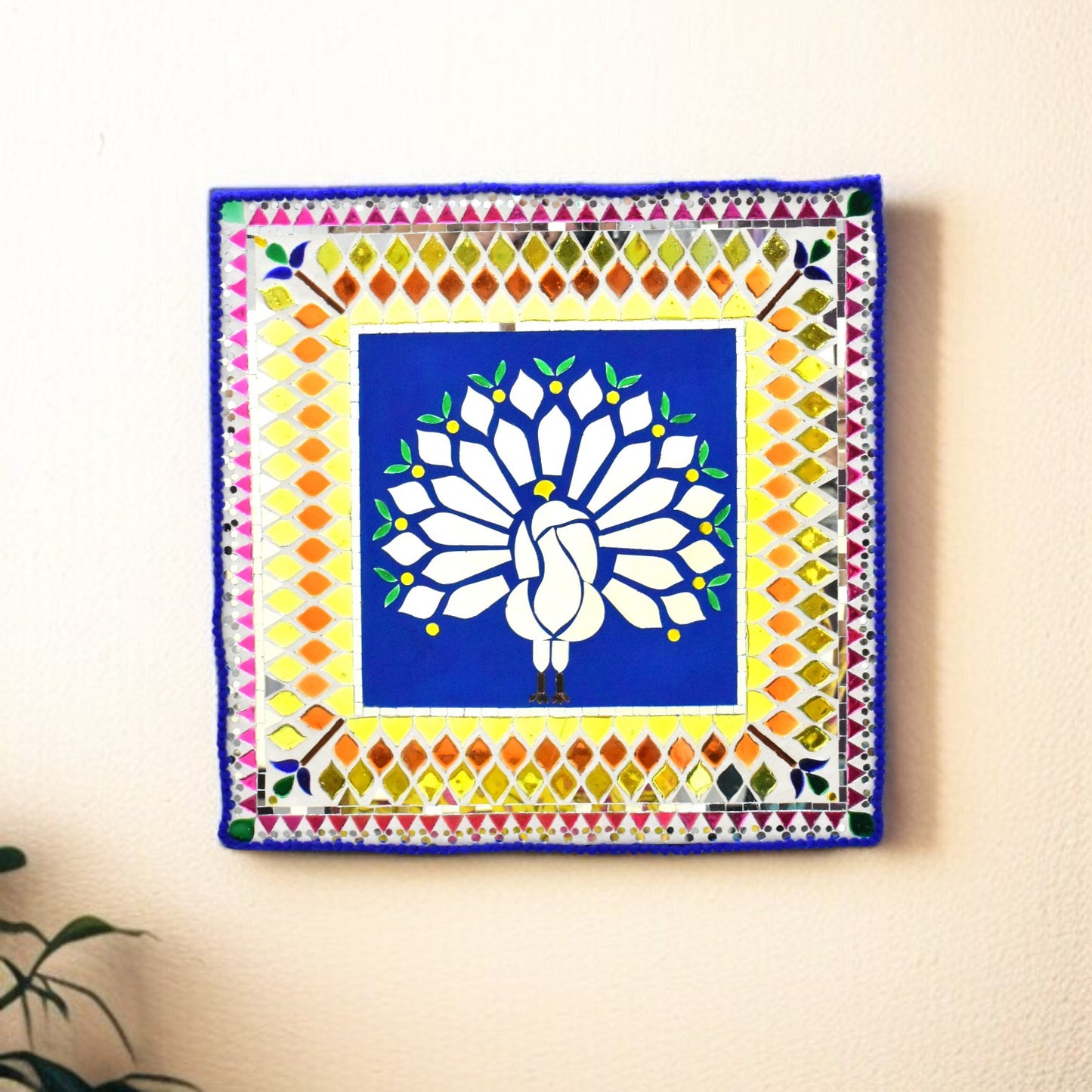 Decorative wall art with a peacock design with a colorful geometric mirror border