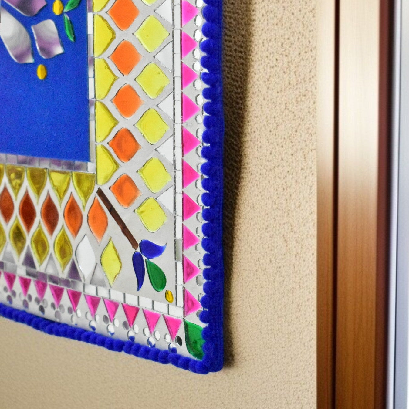 Close up of Colorful mirror mosaic art piece on a wall