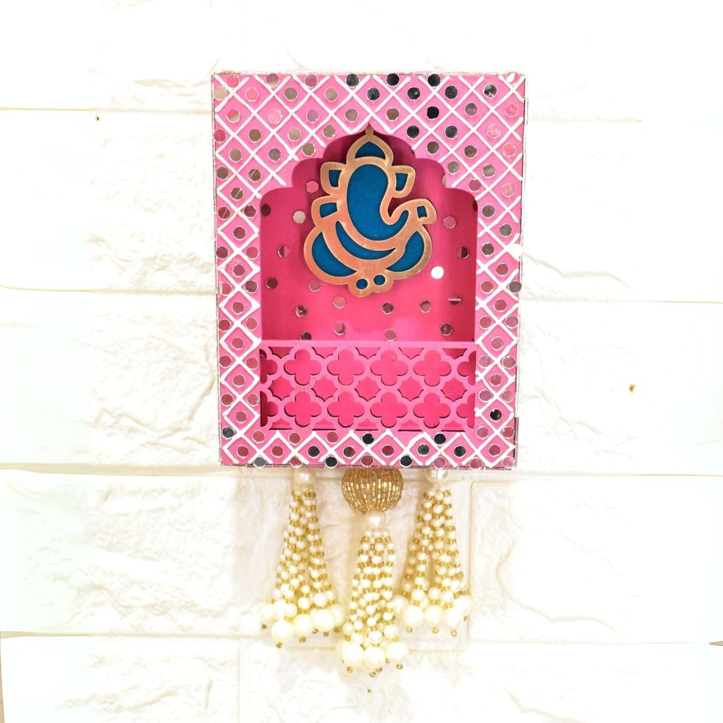 Pink Ganesha wall hanging jharokha with a blue and gold design on a white background