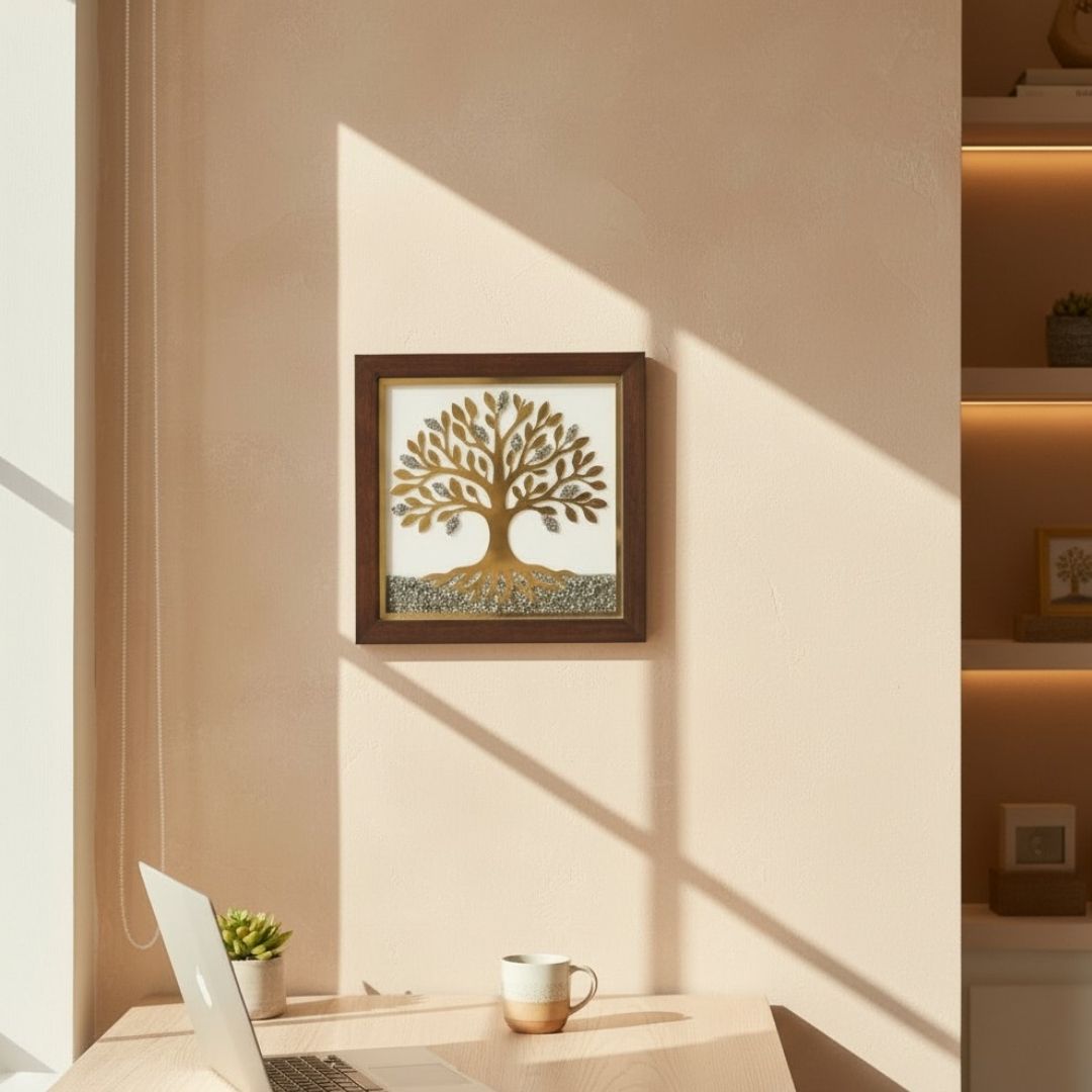 Framed artwork of a white and gold pyrite tree on a wall with a laptop and mug on a desk below.