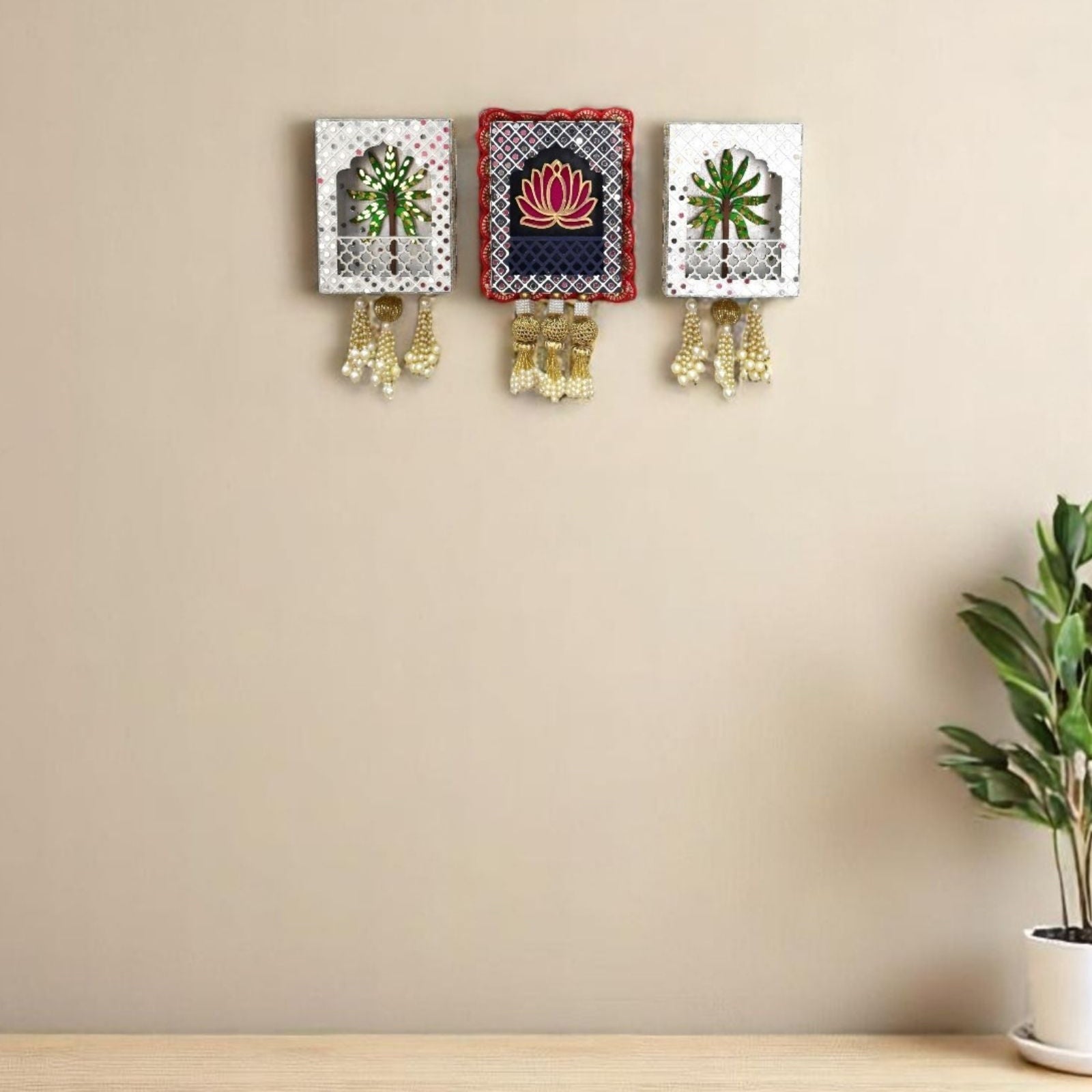 Navy and white Lotus and Tree Jharokha wall hanging with mirrors, beads and pearls tassel a beige wall living room.