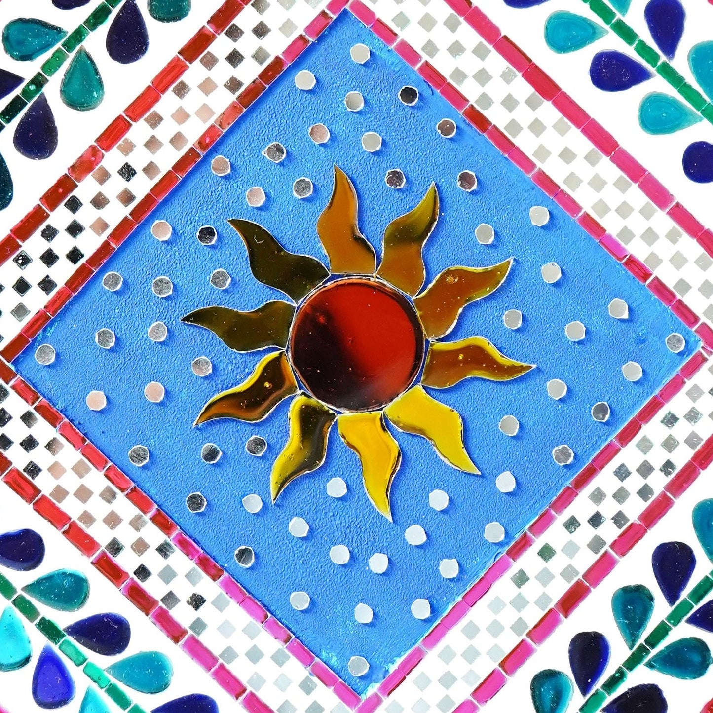 Close up of sun mirror mosaic wall art