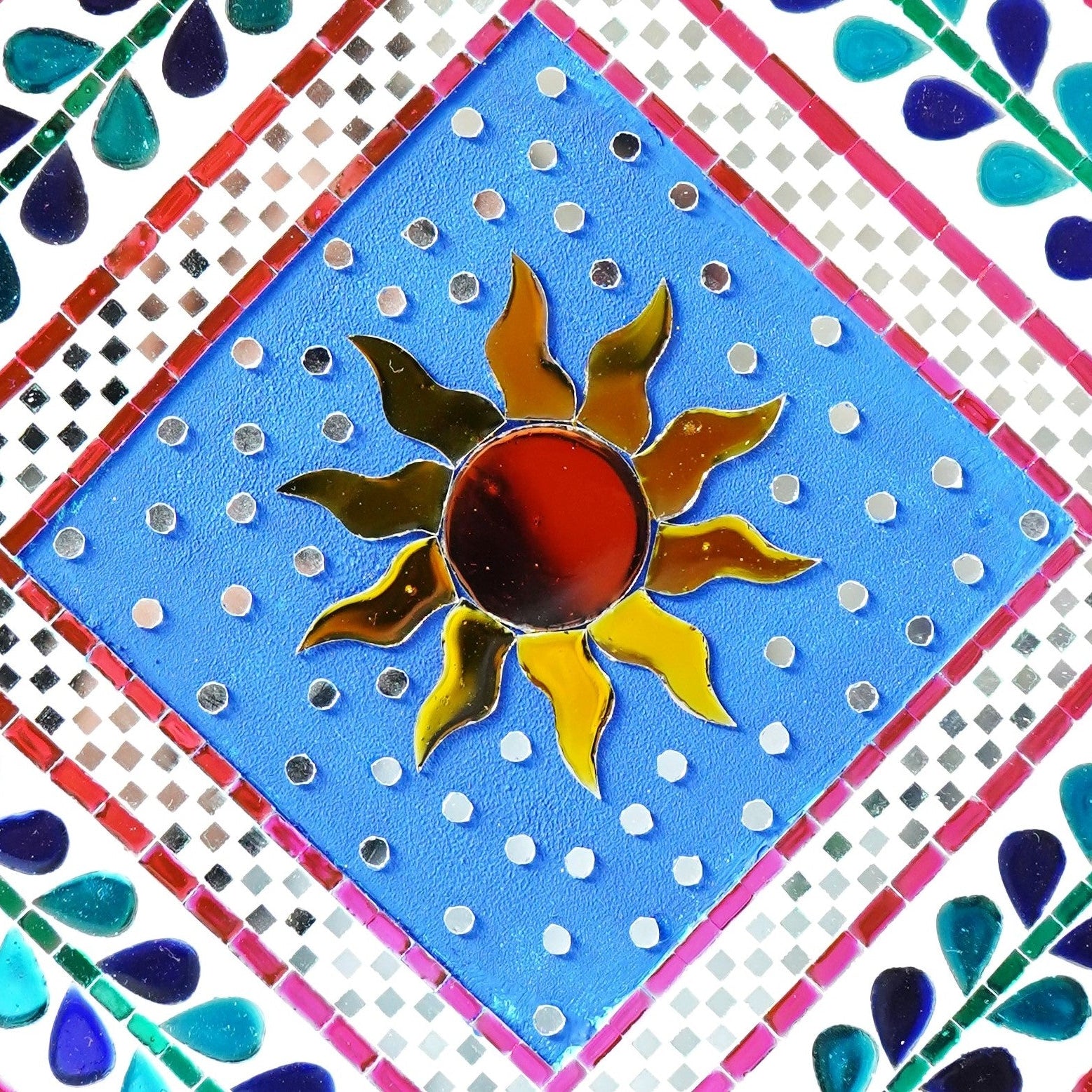 Close up of sun mirror mosaic wall art