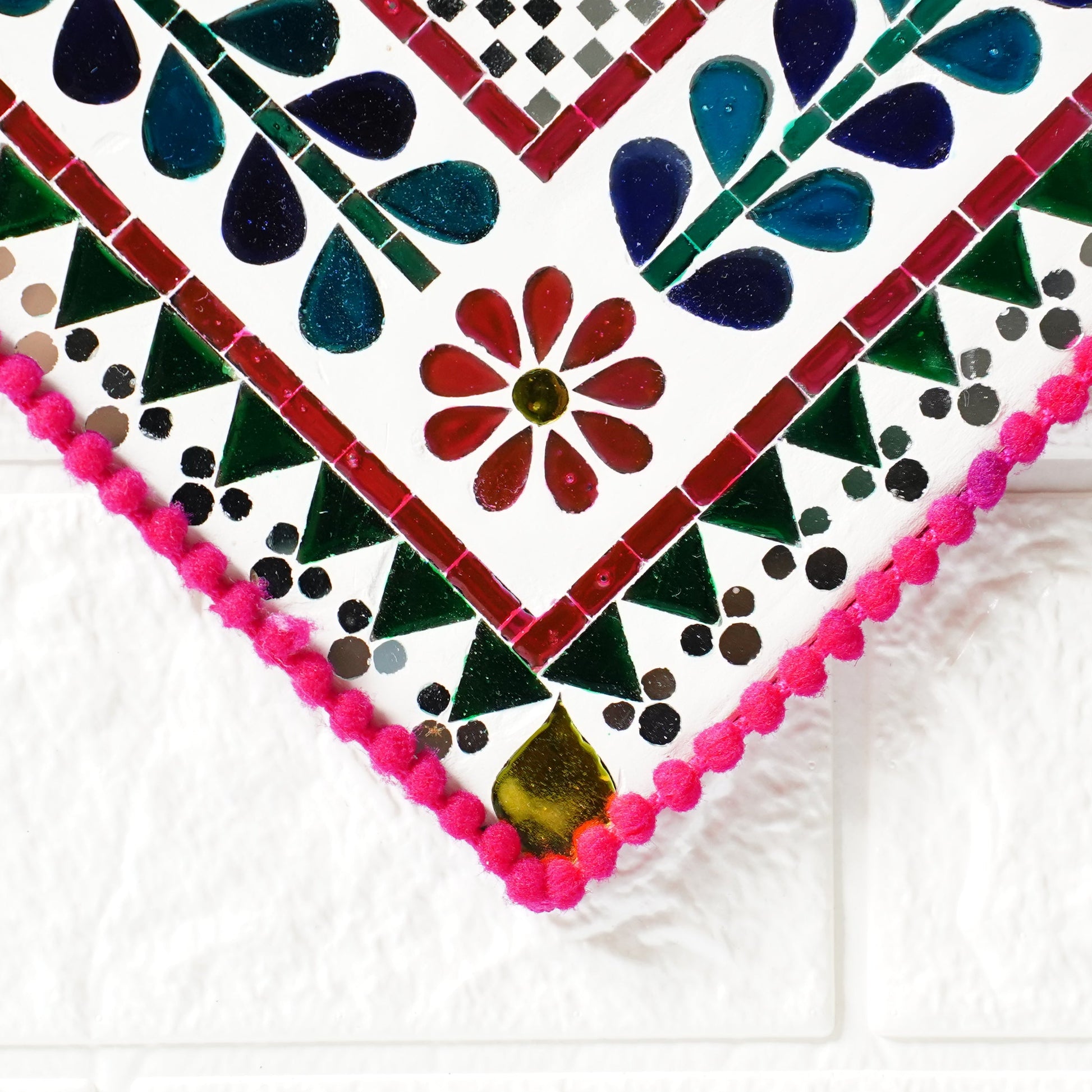 Colorful mirror mosaic with floral patterns on a white background