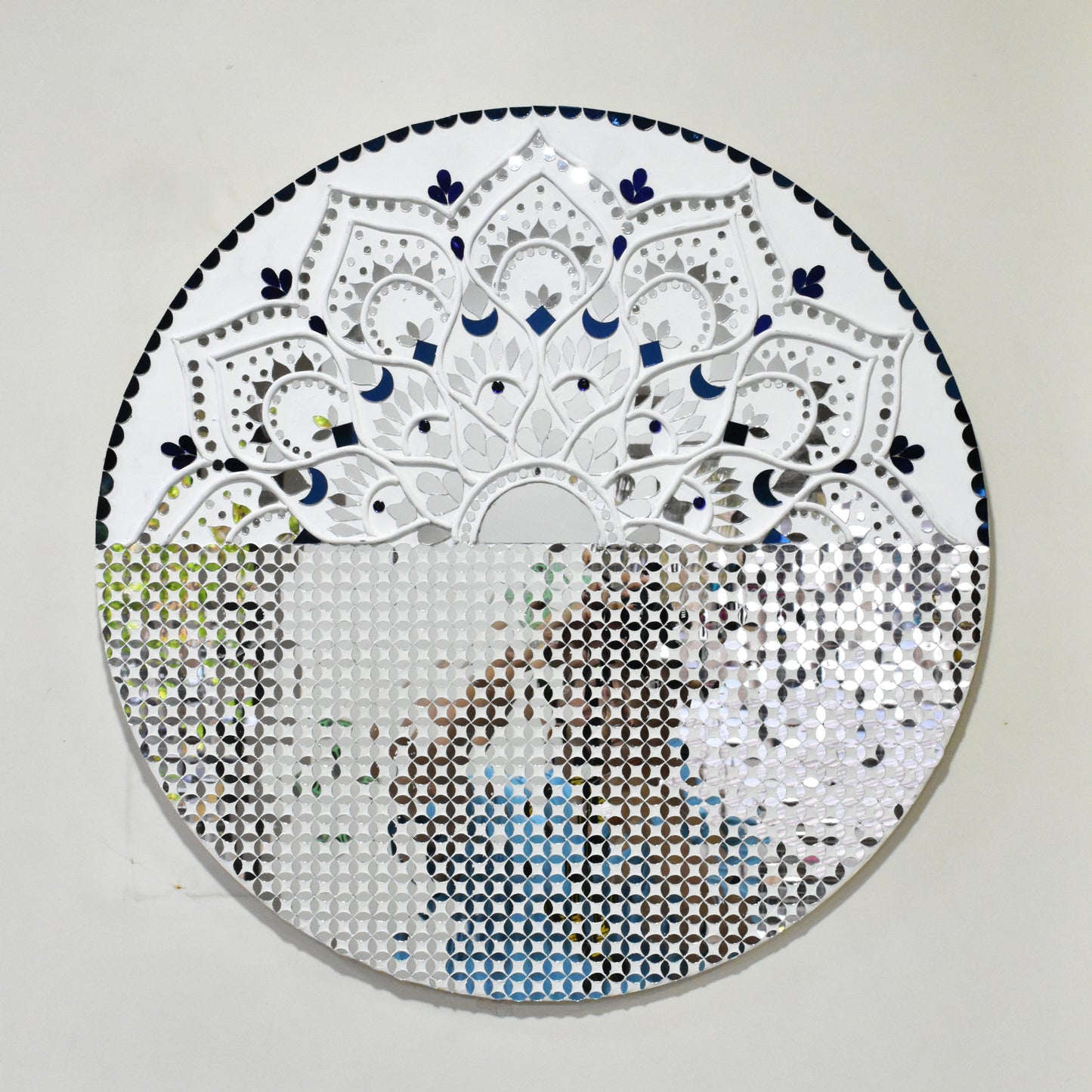 Circular mandala mirror mosaic art piece with intricate patterns on a plain background