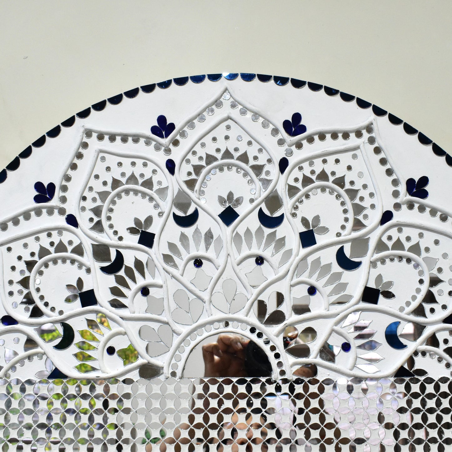 Mandala mirror mosaic wall art with intricate patterns on a plain background