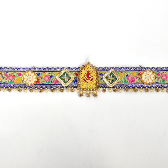 Decorative Ganpati Toan with colorful patterns and gold accents on a white background