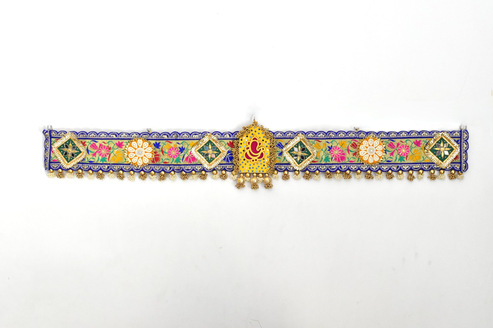 Decorative Ganpati Toan with colorful patterns and gold accents on a white background