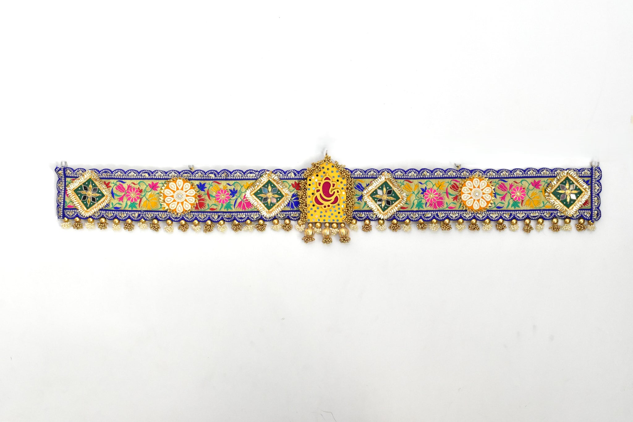 Decorative Ganpati Toan with colorful patterns and gold accents on a white background