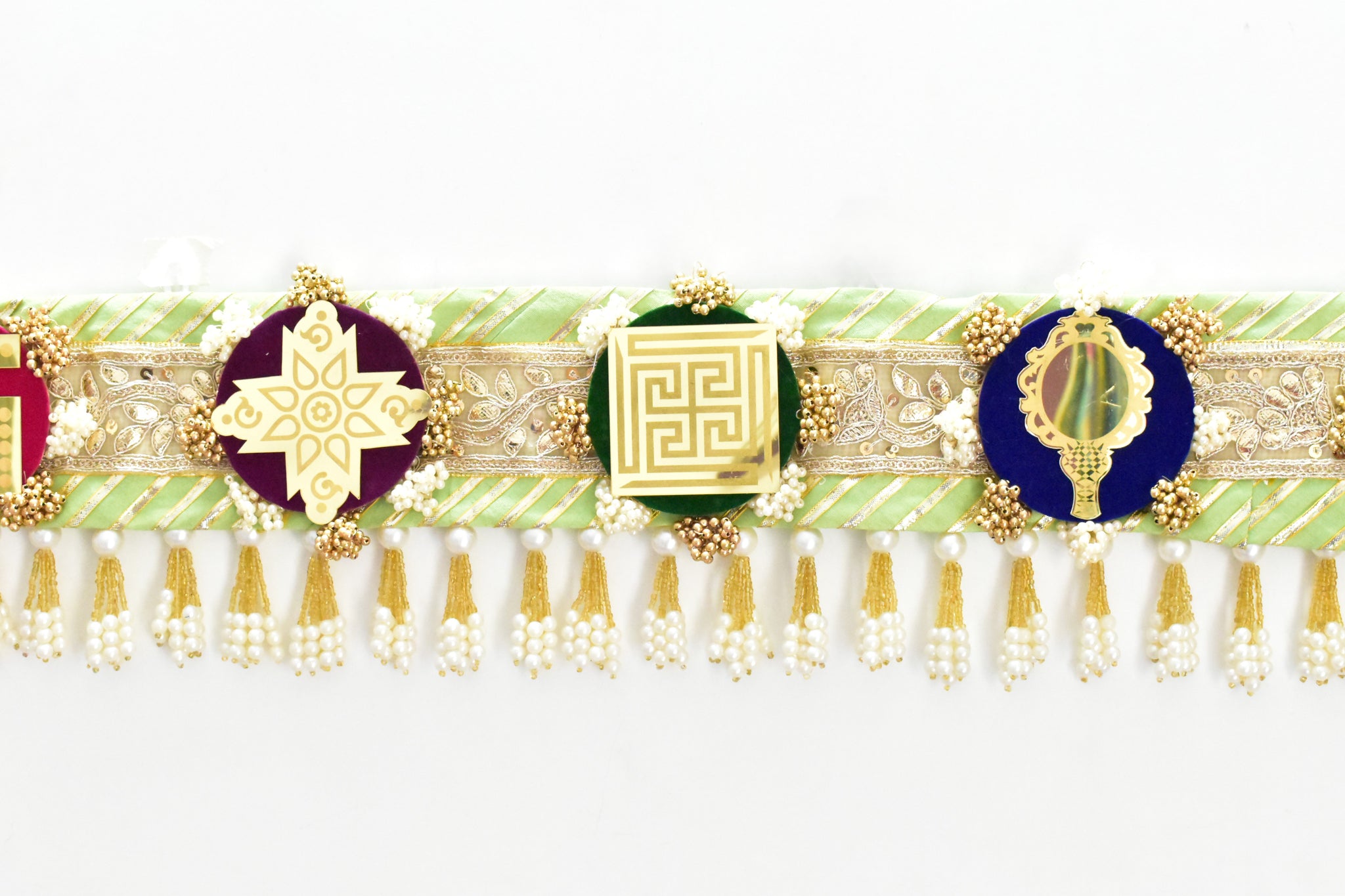 Green handcrafted Ashthamangala toran with traditional mirror work and 8 sacred symbols, ideal for ethnic home décor, door hanging, or pooja room decoration