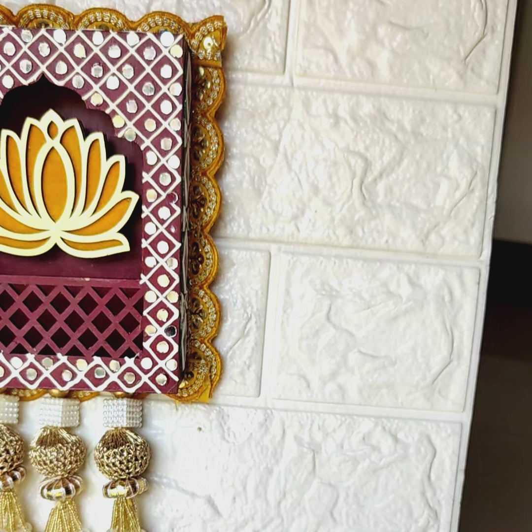 A set of three handcrafted wall hangings featuring Lord Ganesha with a lotus flower design, in blue, red, and gold colors, with decorative elements.